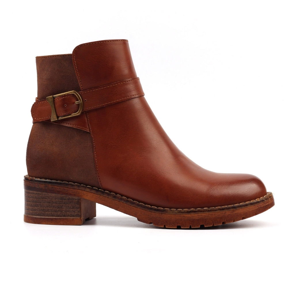 Brown leather boot with a buckle on a white background